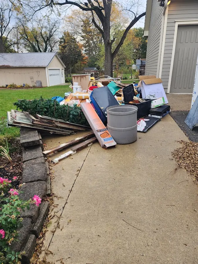 Dumpster being loaded with debris for 12 Yard Dumpster Rental in Hobart